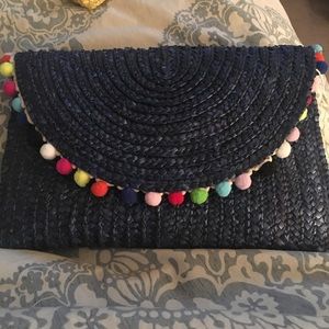 Navy clutch with colored Pom Poms